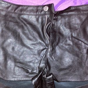 Cute black leather shorts.
